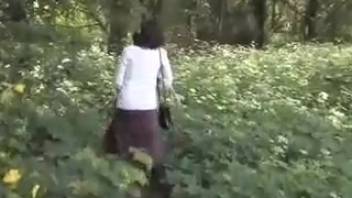 Lady peeing in the shrubbery