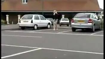 Young woman urinating beside the vehicle in the parking area