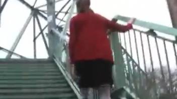 Young woman defecating on the staircase