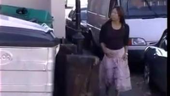 Japanese woman urinating in the car park