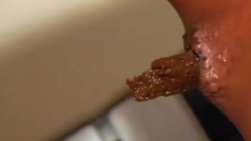 Chick defecating in the kitchen and getting anal from a cock
