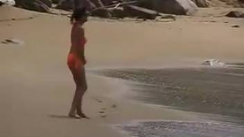 Izobella urinating on the shore