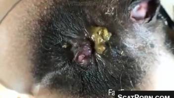 Young woman with a dark, bushy vagina releases gas and defecates